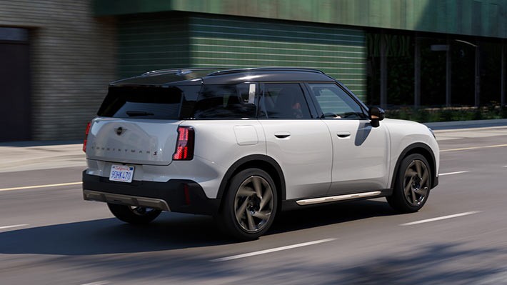 Insured Warranty. MINI Countryman driving down the road.